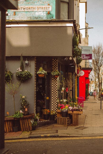 A charming storefront of flowersmanorhouse.co.uk on Green Lanes and Finsbury Park, featuring a variety of fresh floral arrangements displayed outside. In the foreground, colorful bouquets of roses, tu
